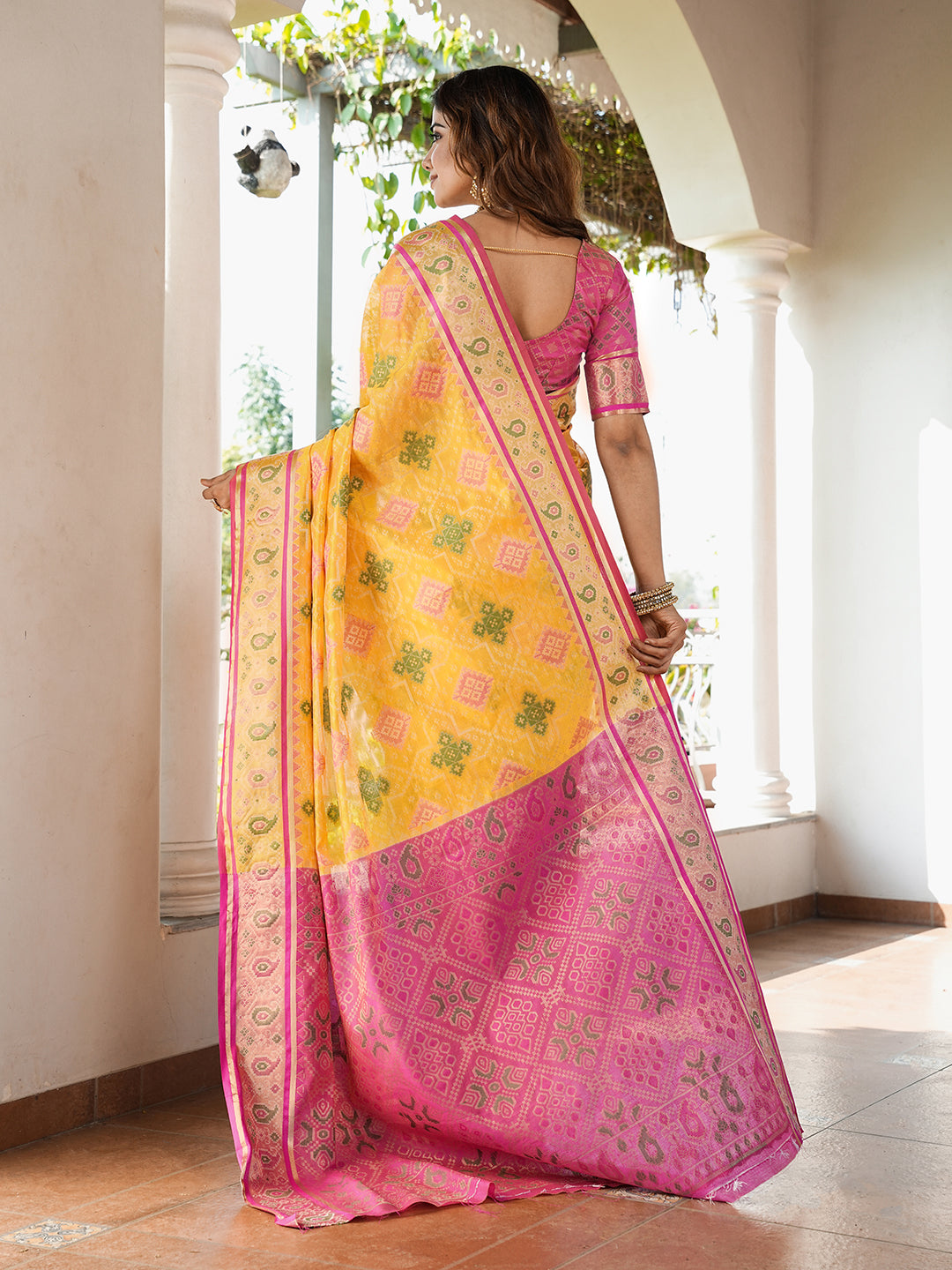 Yellow organza zari woven patola saree