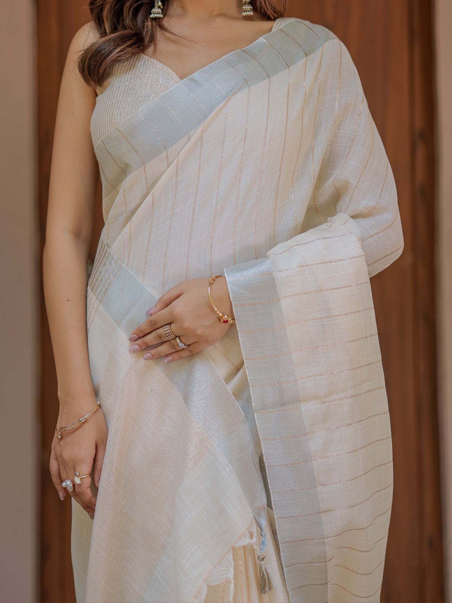 Ivory Cream Pure Handloom Mul Cotton Saree with Golden Striped Weaving & Tassel Detailing