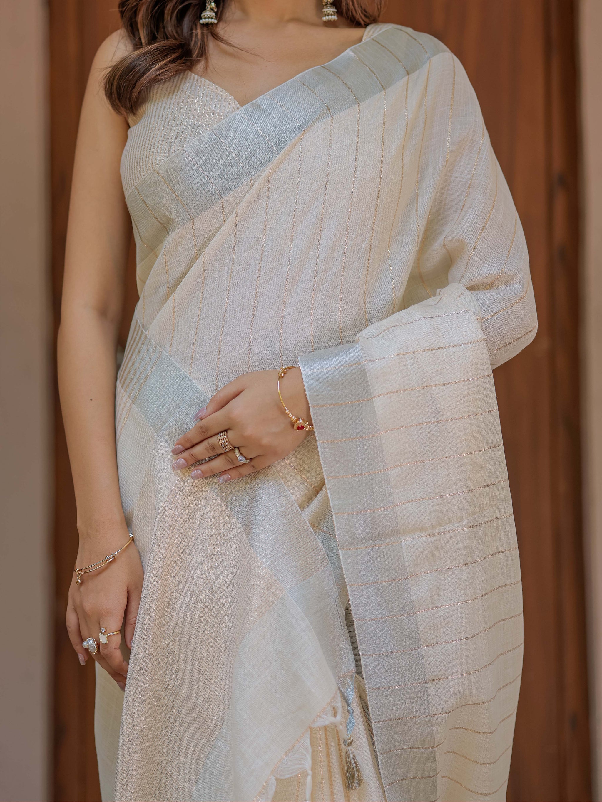 Ivory Cream Pure Handloom Mul Cotton Saree with Golden Striped Weaving & Tassel Detailing