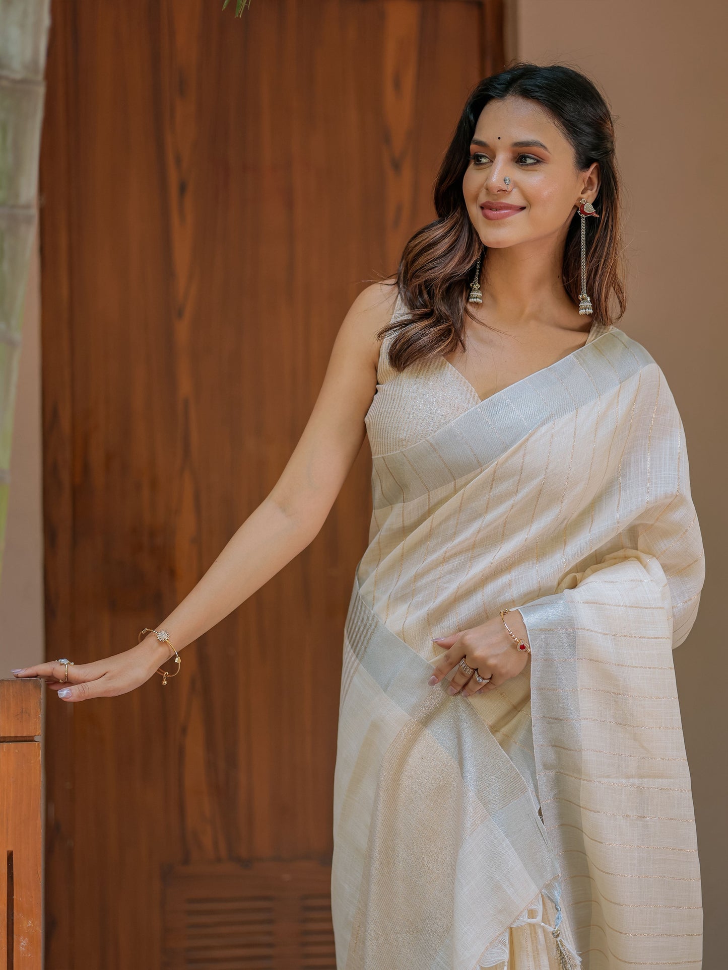 Ivory Cream Pure Handloom Mul Cotton Saree with Golden Striped Weaving & Tassel Detailing