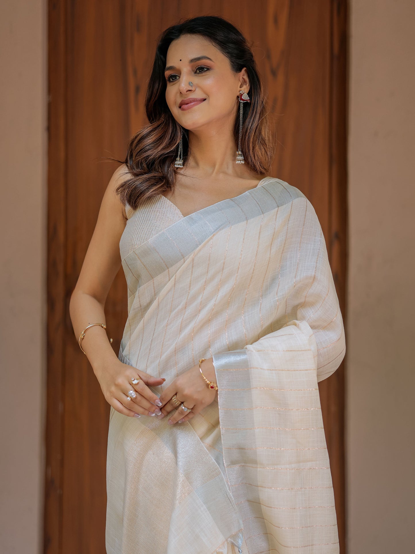 Ivory Cream Pure Handloom Mul Cotton Saree with Golden Striped Weaving & Tassel Detailing