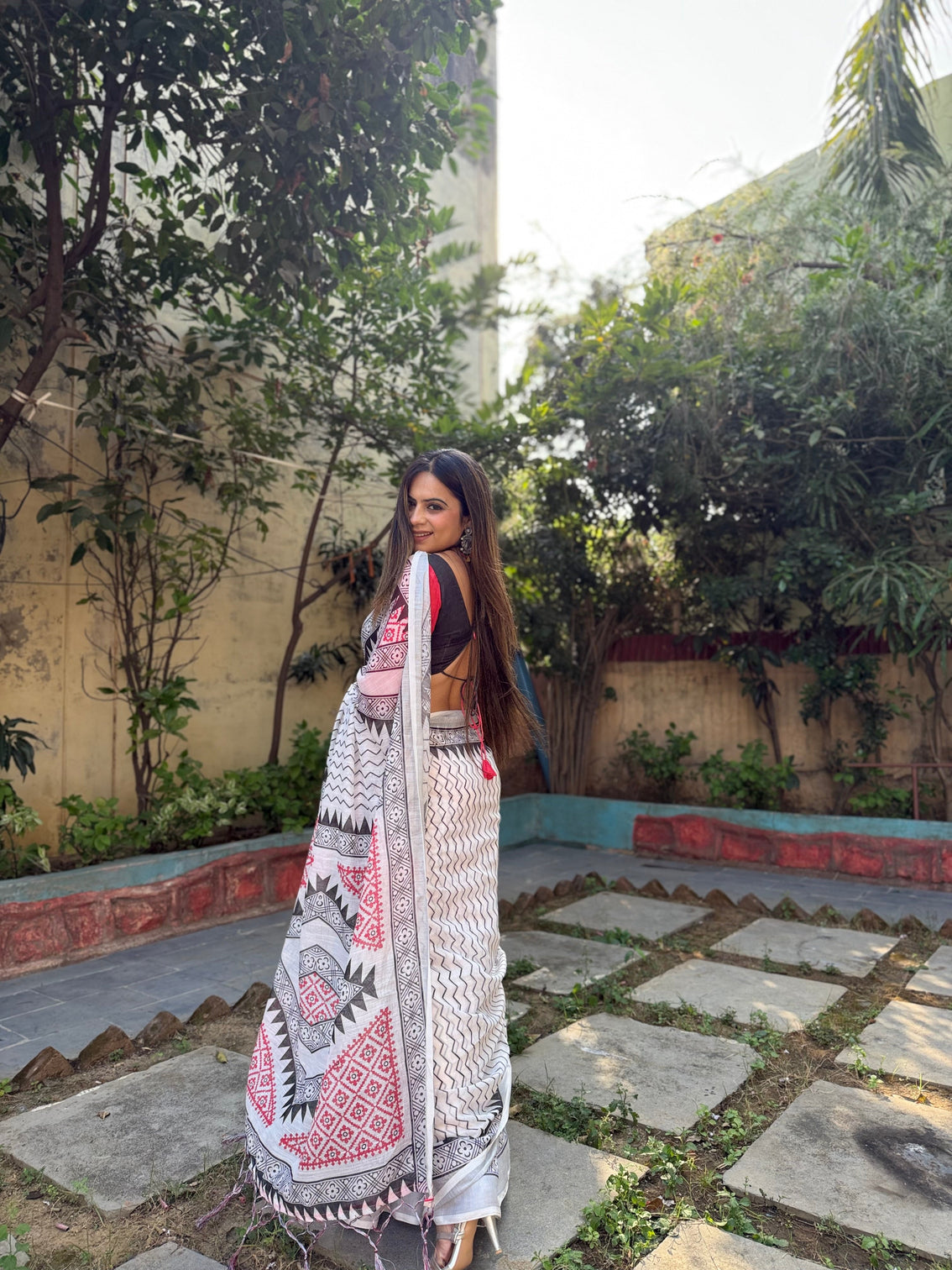 Elegant white pure linen digital printed saree with chevron design and intricate red black geometric pallu tassel details and matching blouse piece