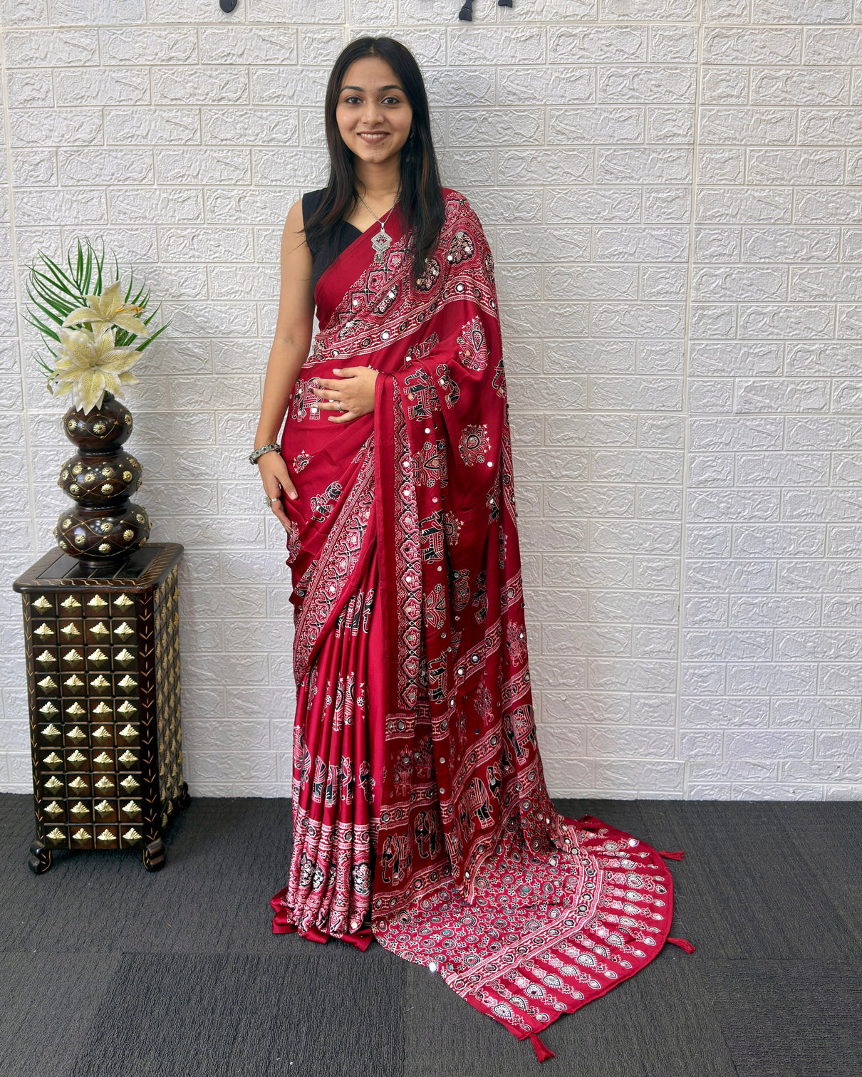 Maroon modal silk ajrakh print saree with traditional elephant motifs designer pallu tassels festive ethnic wear saree