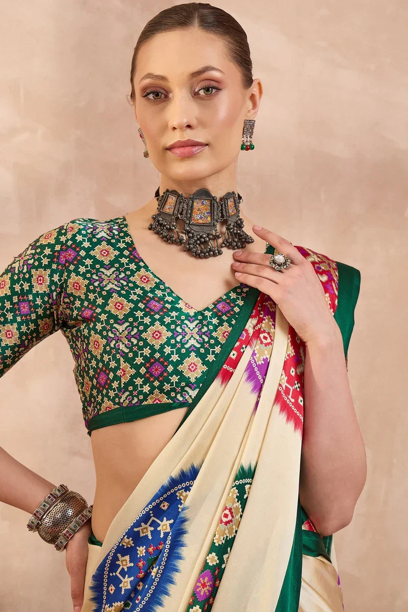 Cream modal silk saree with multicolor patola inspired print emerald green border traditional festive wear saree