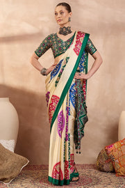 Cream modal silk saree with multicolor patola inspired print emerald green border traditional festive wear saree mameraa