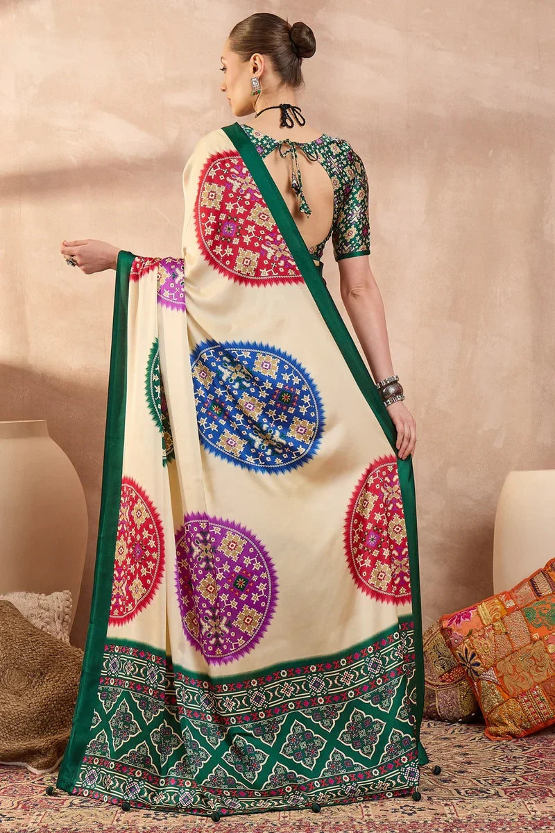 Cream modal silk saree with multicolor patola inspired print emerald green border traditional festive wear saree