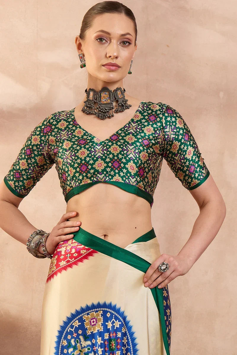Cream modal silk saree with multicolor patola inspired print emerald green border traditional festive wear saree