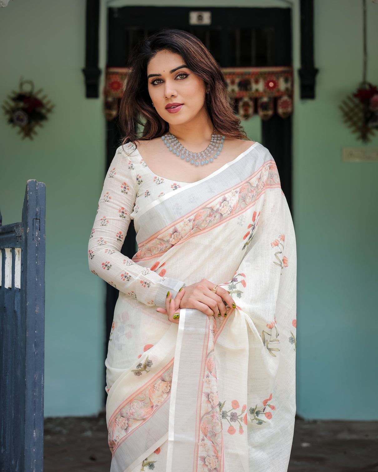 Ivory pure cotton linen saree with pastel floral design blouse and tassel detailing