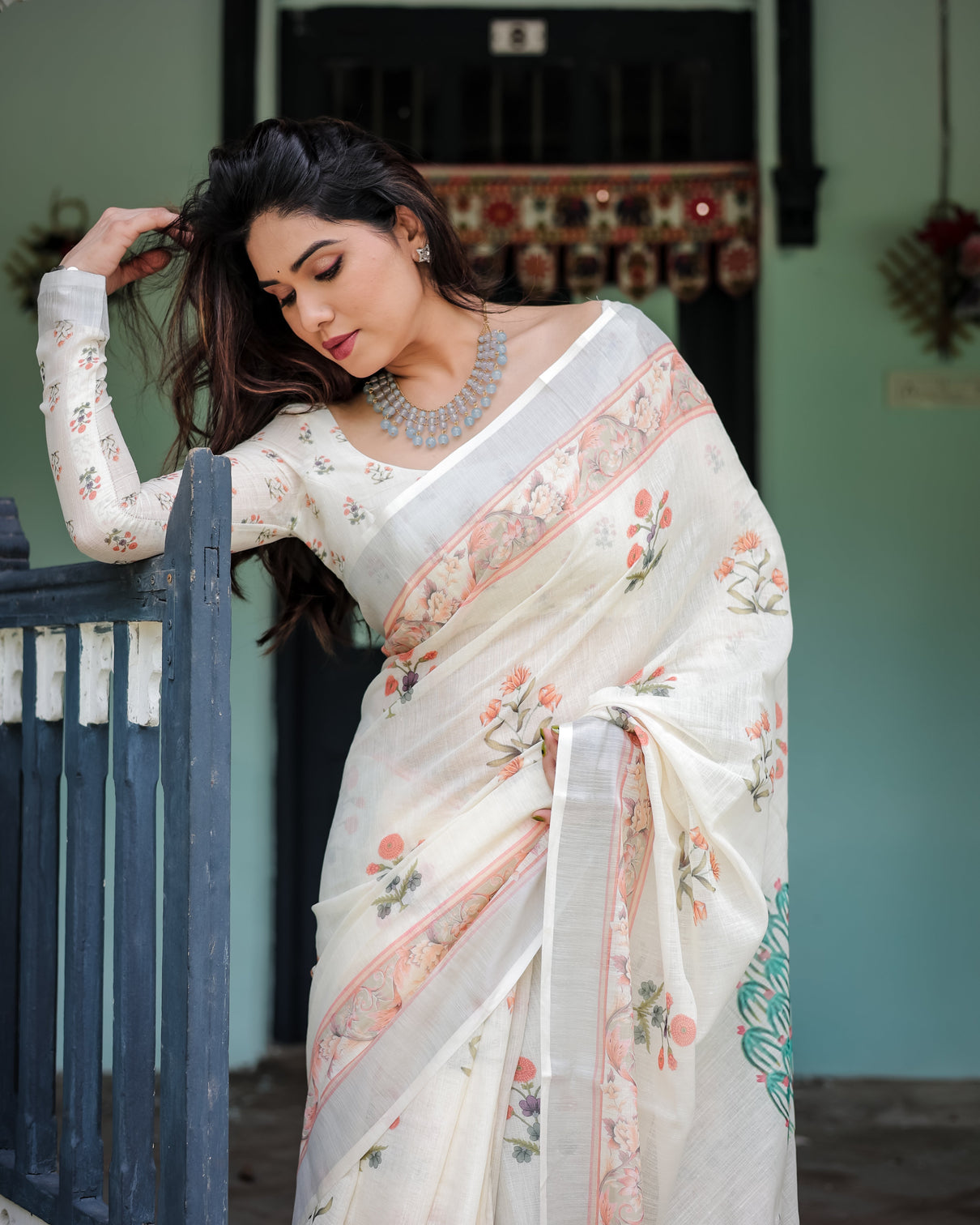 Ivory pure cotton linen saree with pastel floral design blouse and tassel detailing