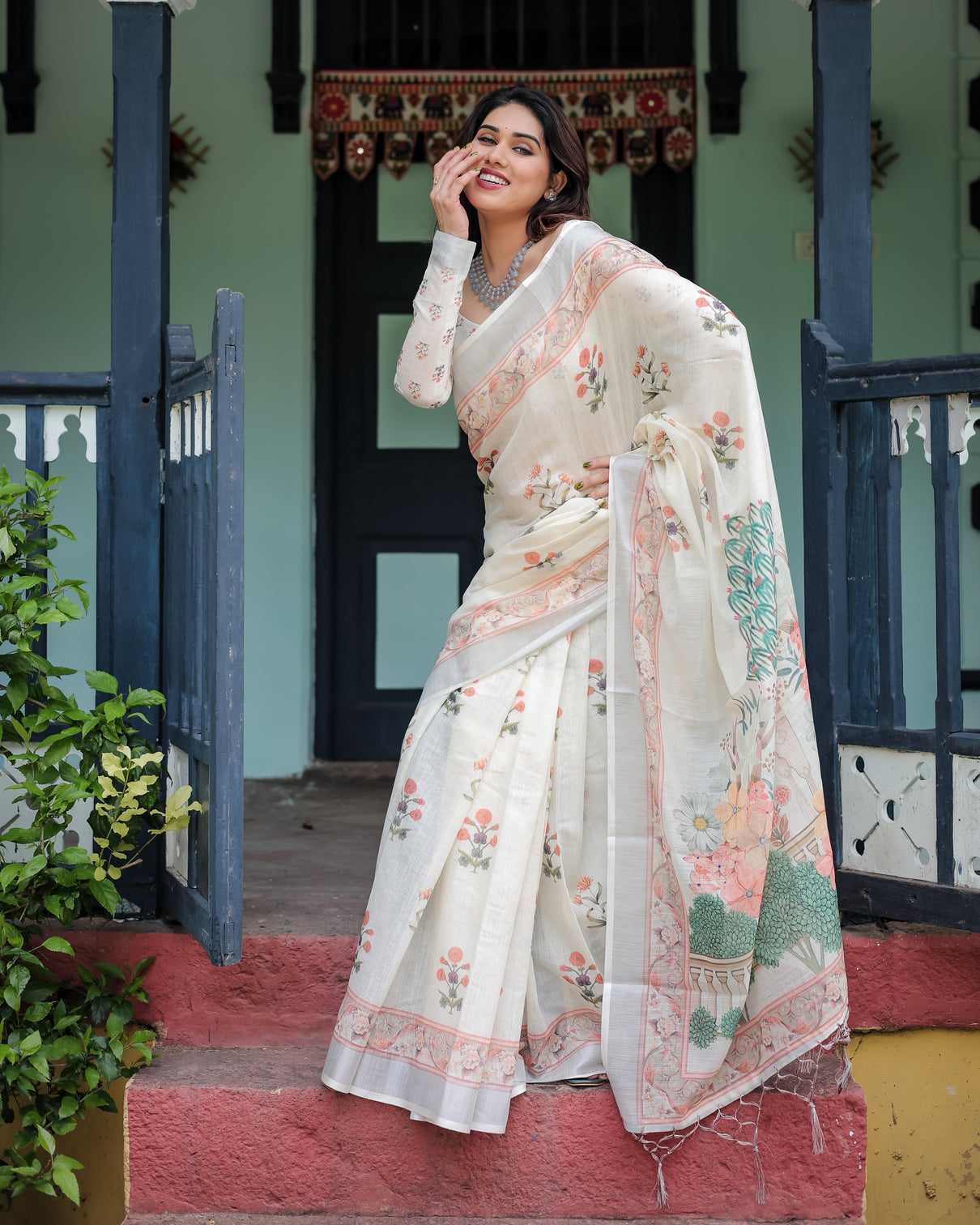Ivory pure cotton linen saree with pastel floral design blouse and tassel detailing