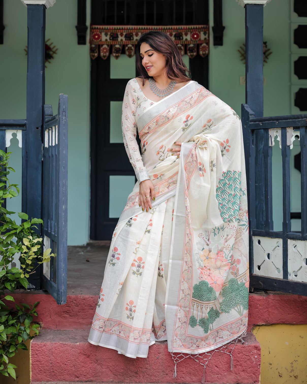 Ivory pure cotton linen saree with pastel floral design blouse and tassel detailing