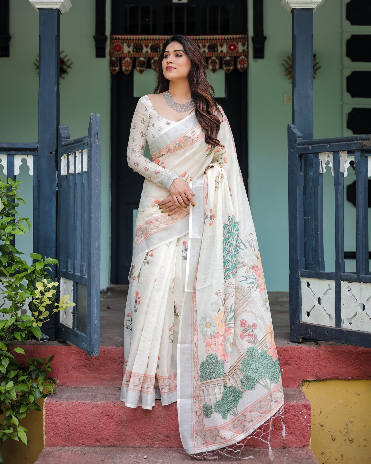 Ivory pure cotton linen saree with pastel floral design blouse and tassel detailing