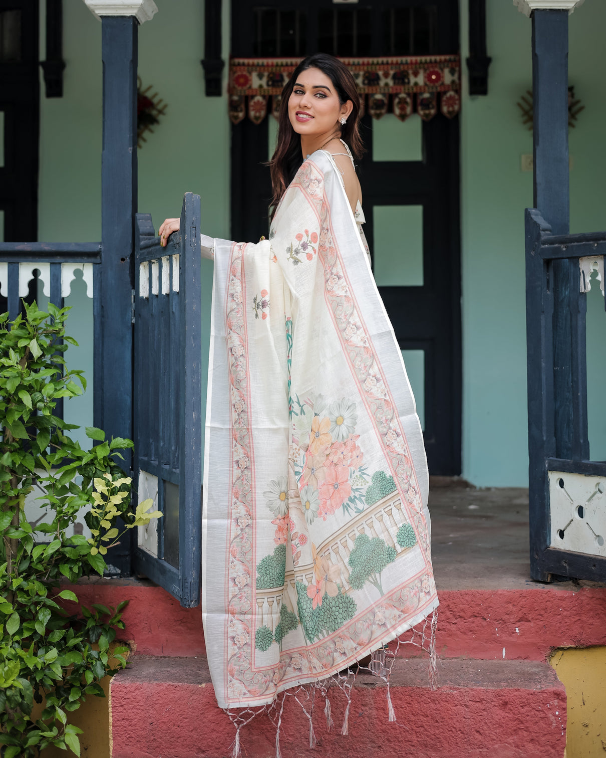 Ivory pure cotton linen saree with pastel floral design blouse and tassel detailing