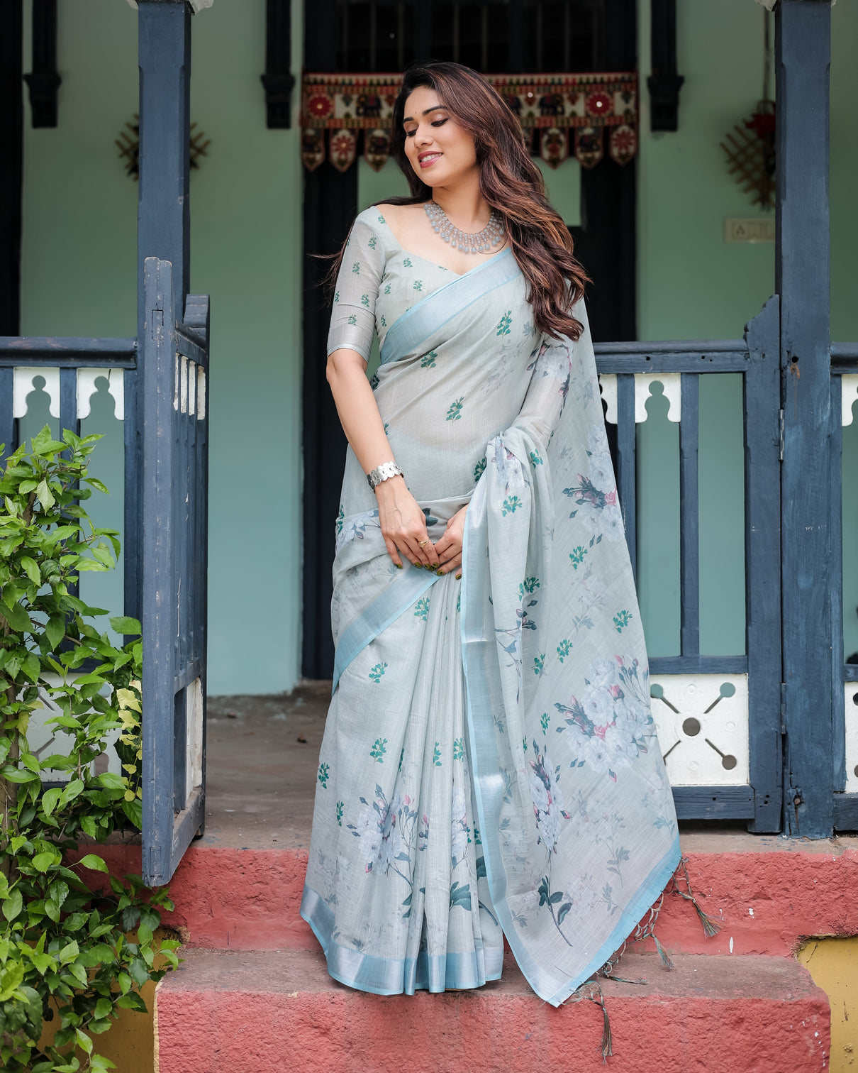 Pastel grey pure cotton linen saree with floral print blouse and tassel detailing