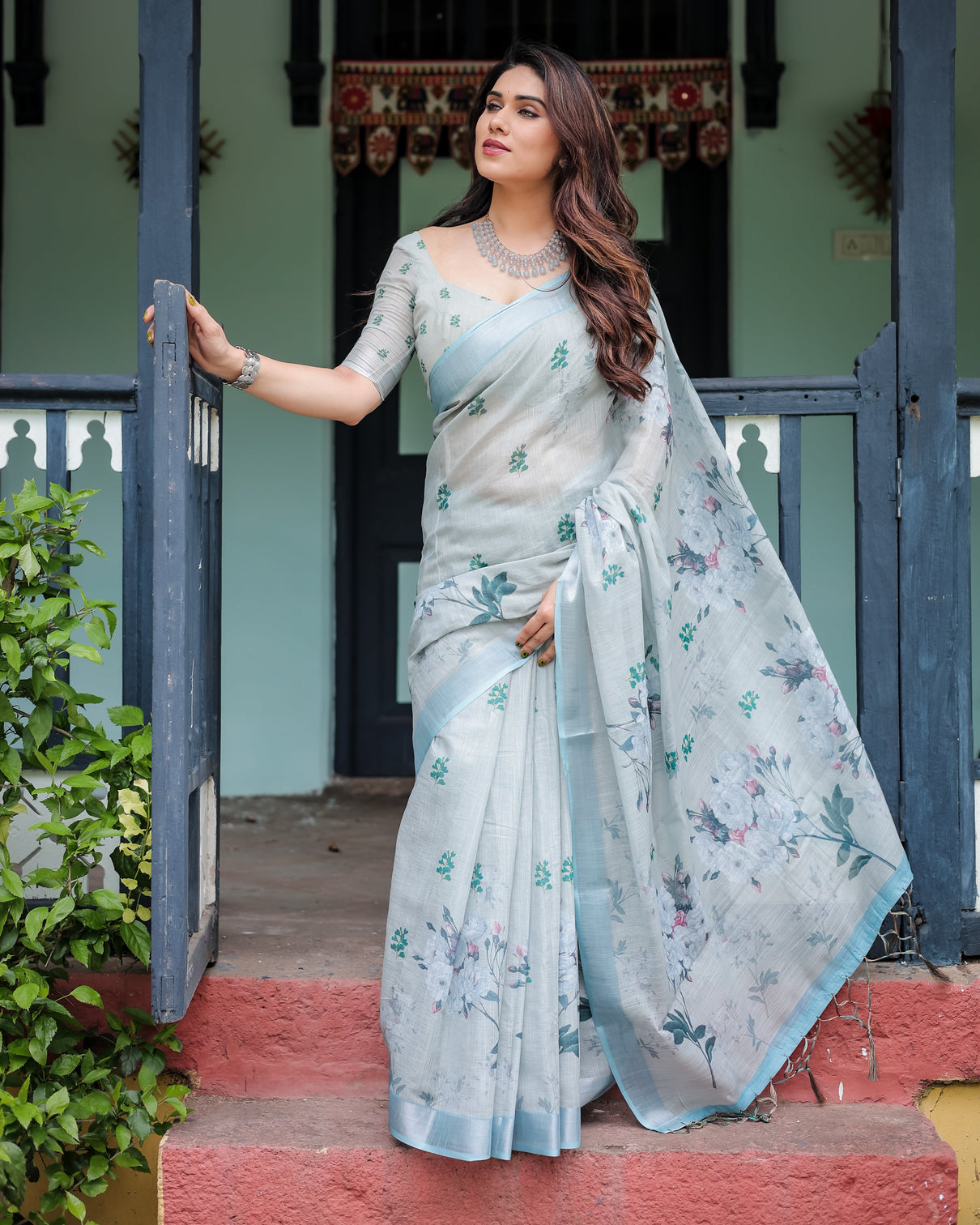 Pastel grey pure cotton linen saree with floral print blouse and tassel detailing