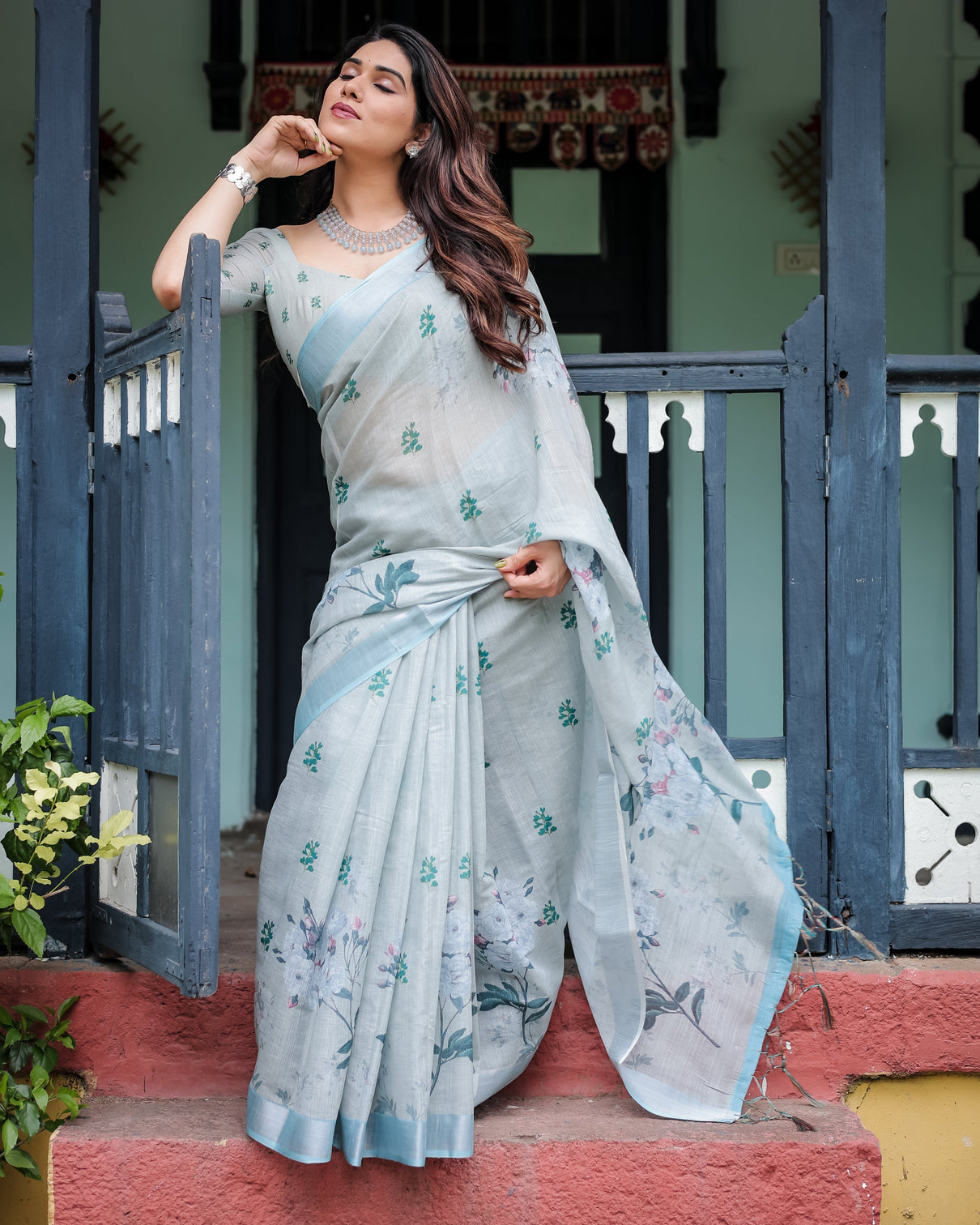 Pastel grey pure cotton linen saree with floral print blouse and tassel detailing