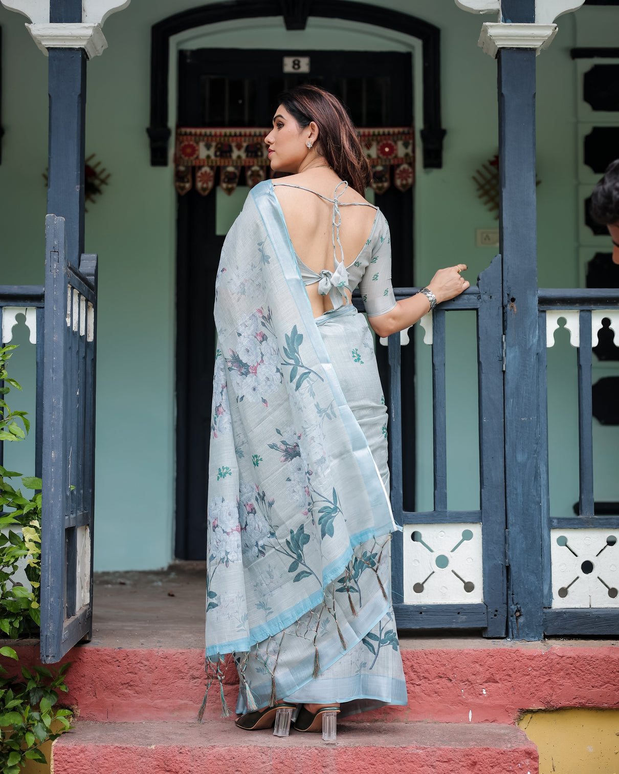 Pastel grey pure cotton linen saree with floral print blouse and tassel detailing