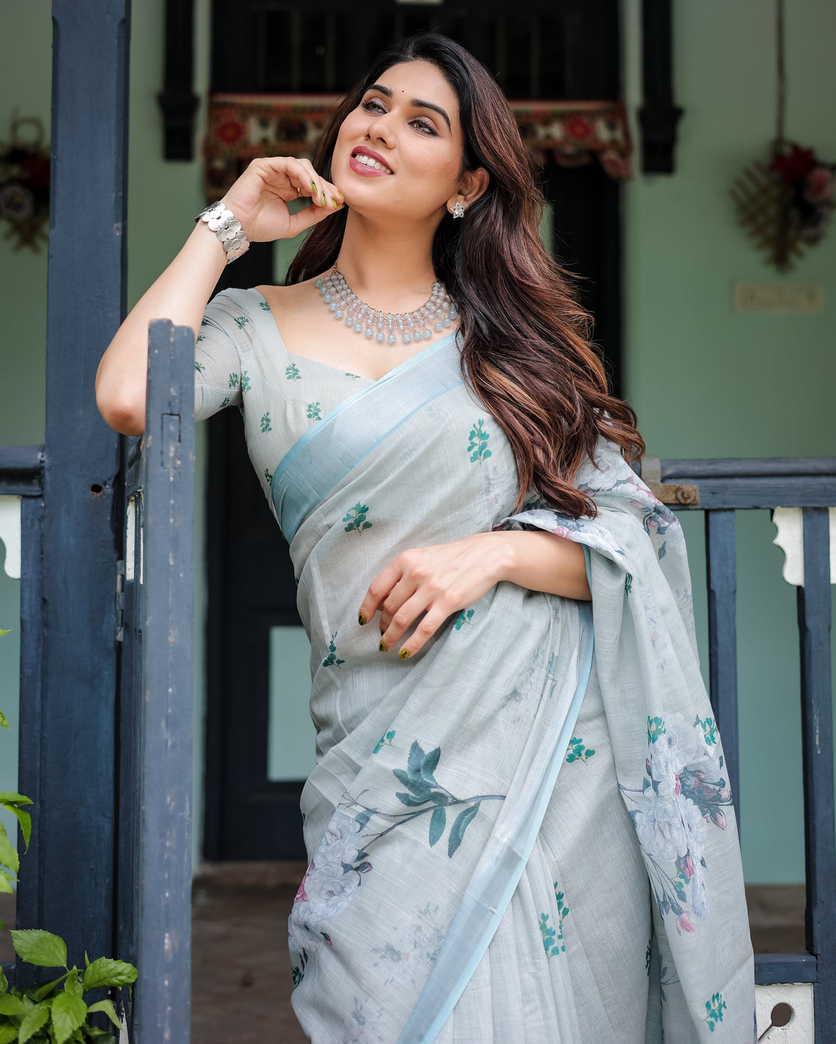Pastel grey pure cotton linen saree with floral print blouse and tassel detailing