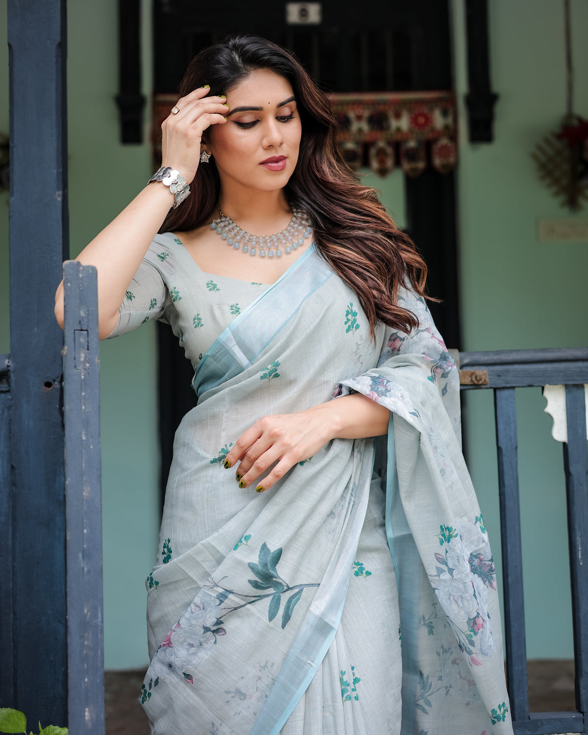 Pastel grey pure cotton linen saree with floral print blouse and tassel detailing