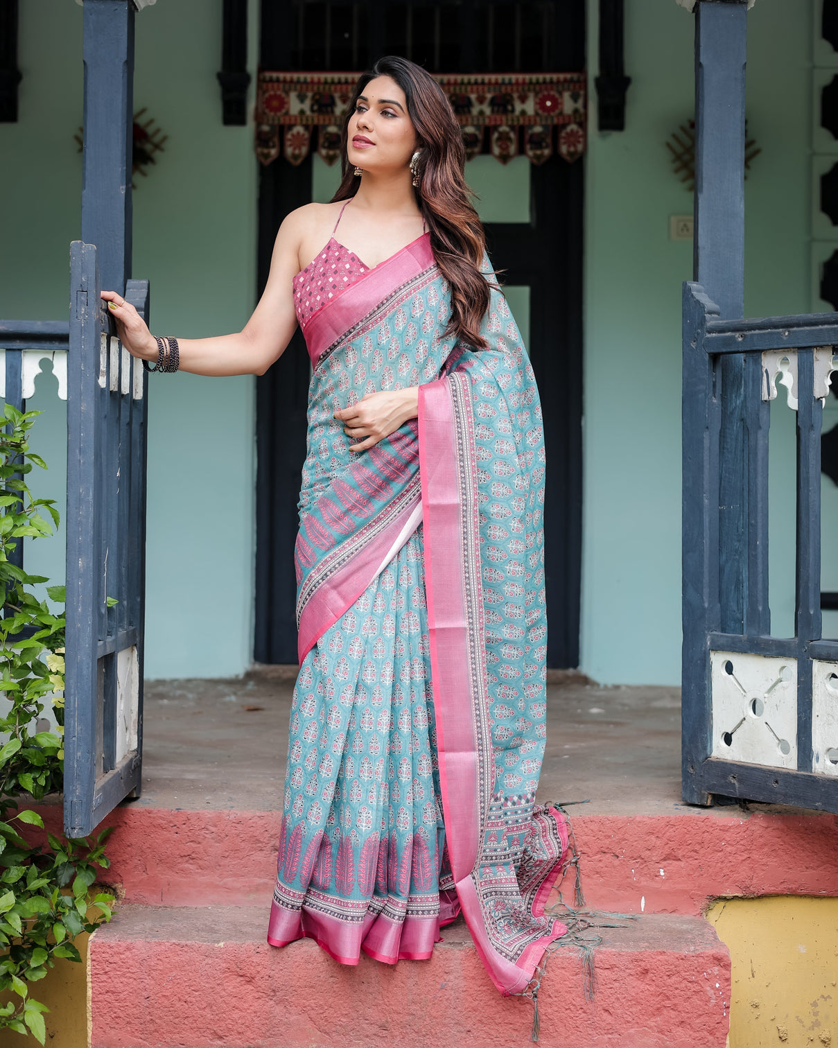 Aqua blue pure cotton linen saree with pink border floral motifs and tassel detailing