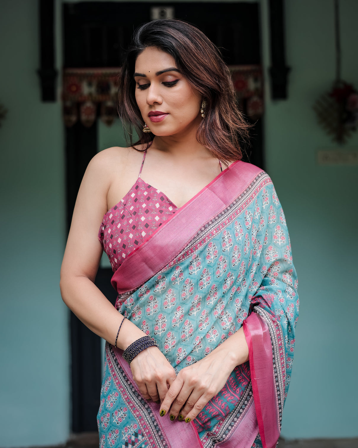 Aqua blue pure cotton linen saree with pink border floral motifs and tassel detailing