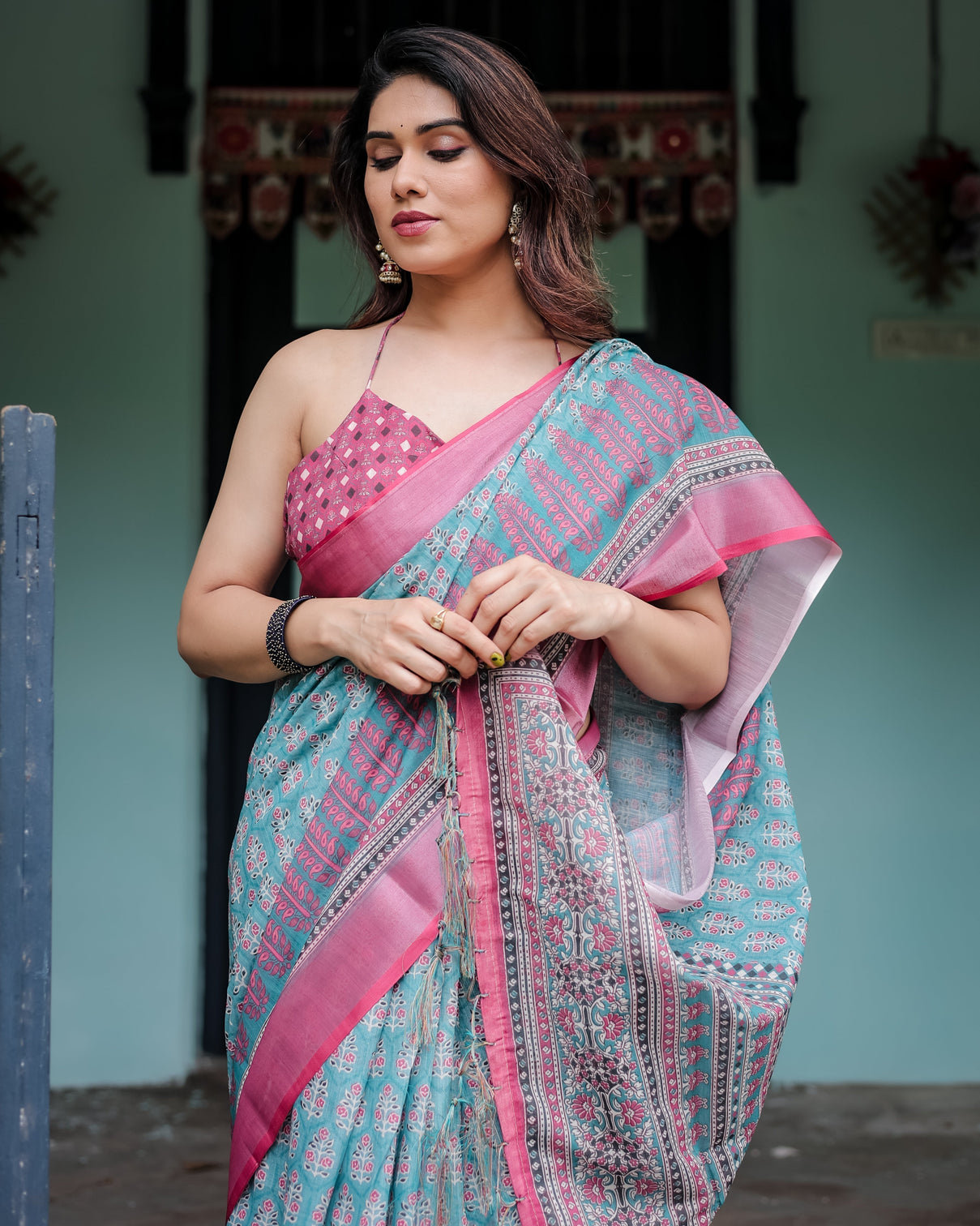 Aqua blue pure cotton linen saree with pink border floral motifs and tassel detailing
