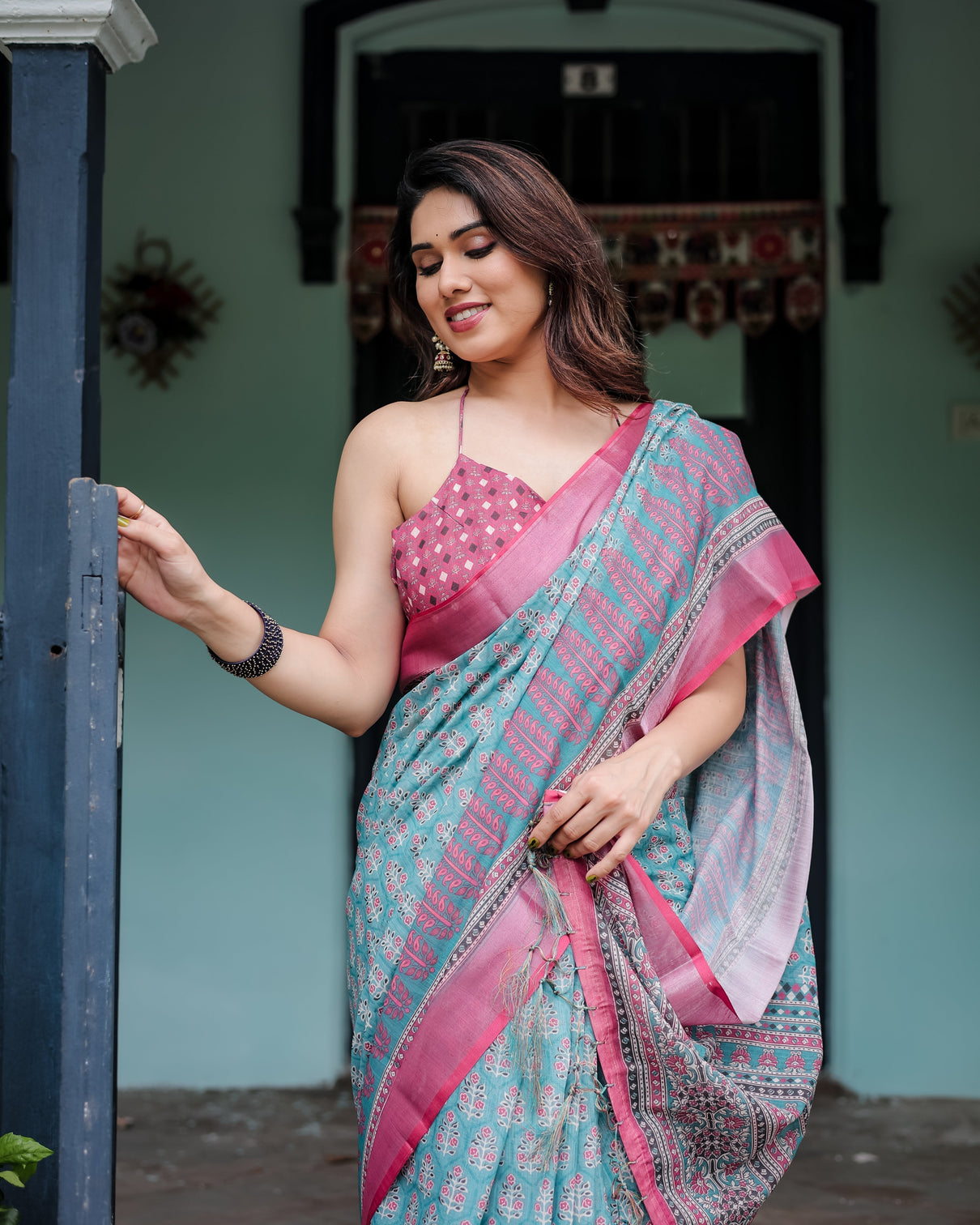 Aqua blue pure cotton linen saree with pink border floral motifs and tassel detailing