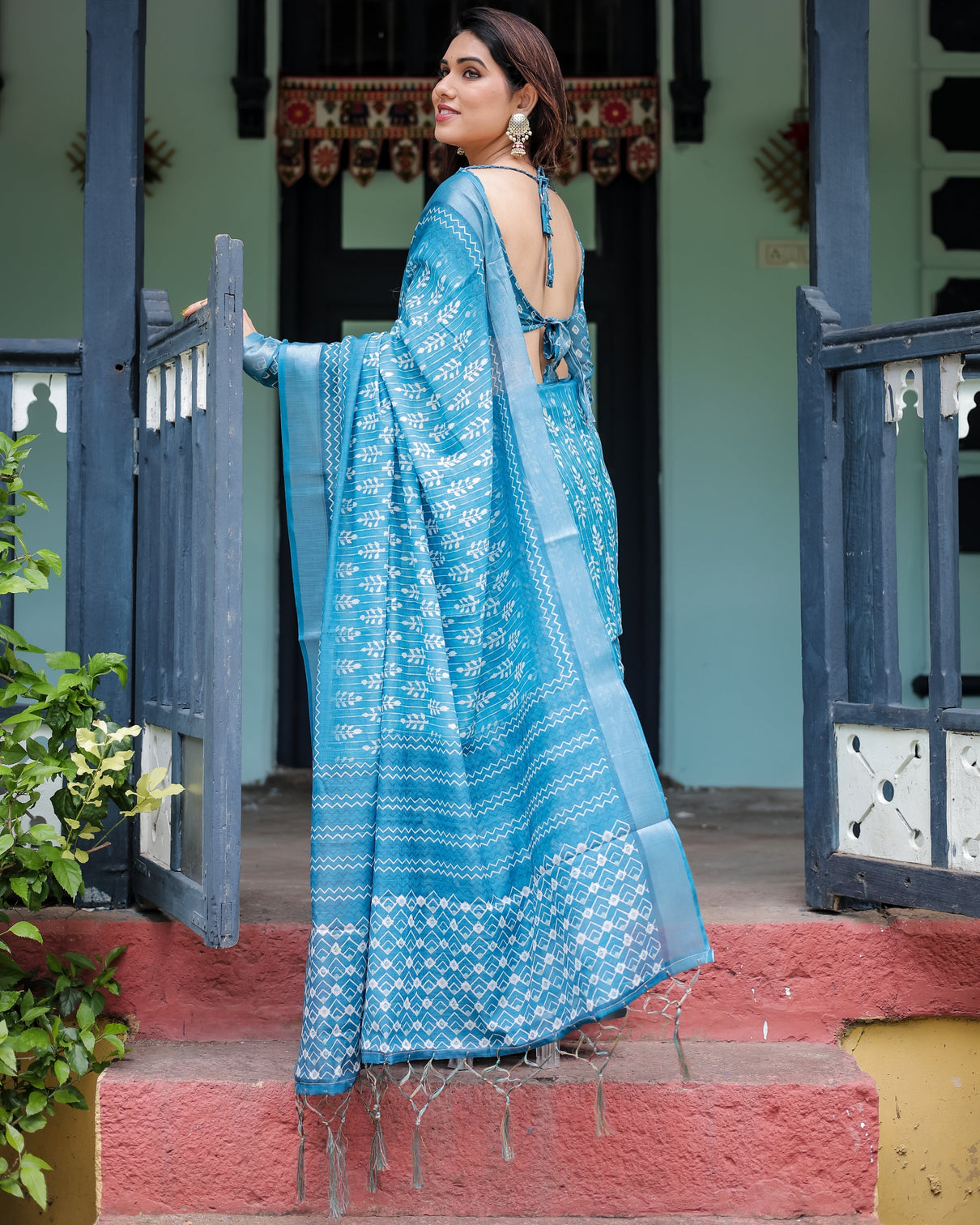 Turquoise pure cotton linen saree with white floral design blouse and tassel edges