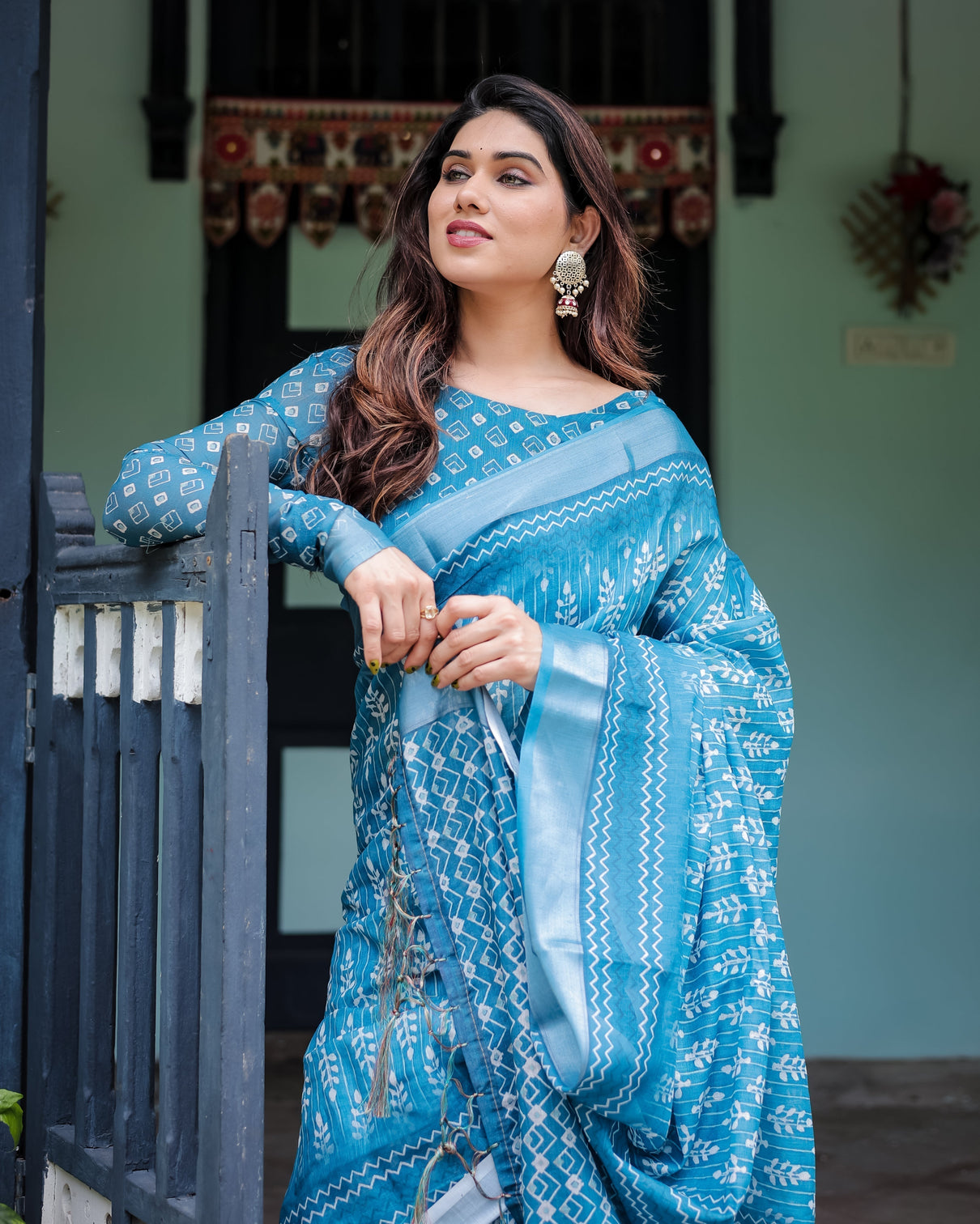 Turquoise pure cotton linen saree with white floral design blouse and tassel edges
