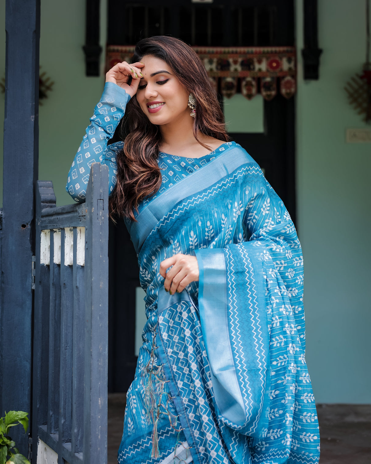 Turquoise pure cotton linen saree with white floral design blouse and tassel edges