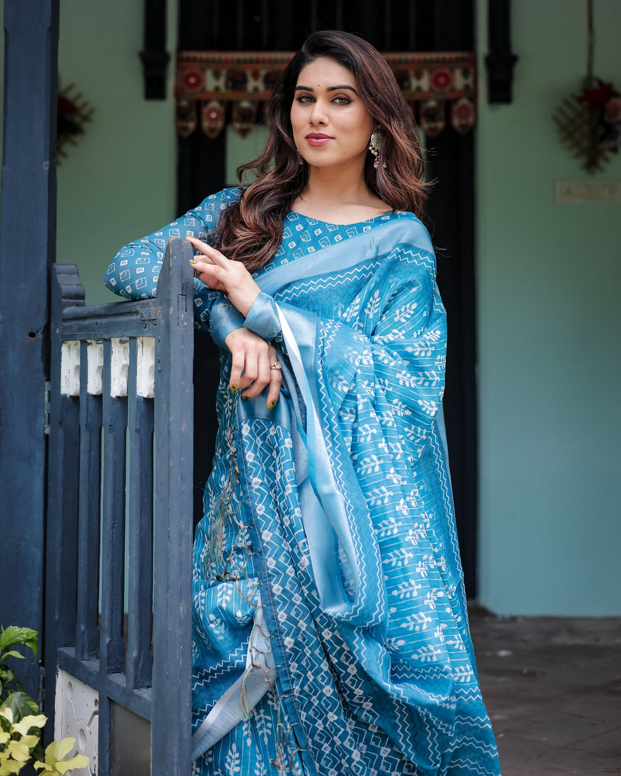 Turquoise pure cotton linen saree with white floral design blouse and tassel edges