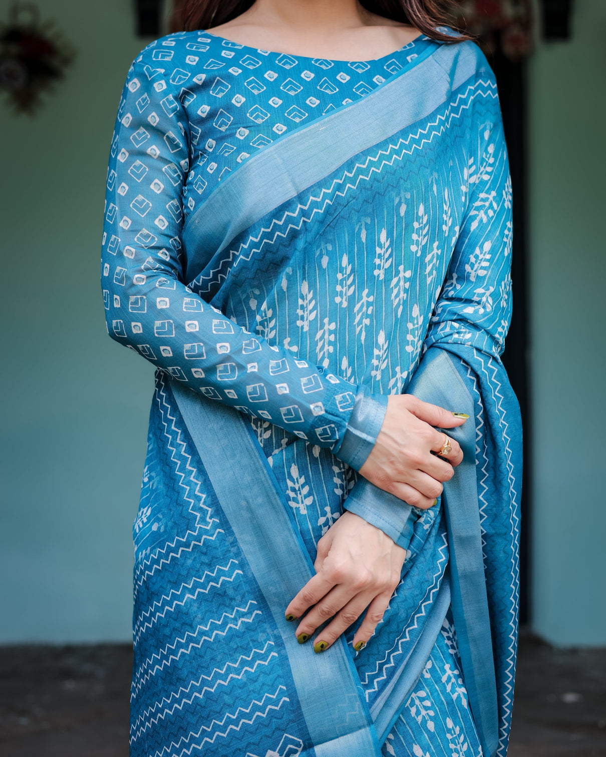 Turquoise pure cotton linen saree with white floral design blouse and tassel edges