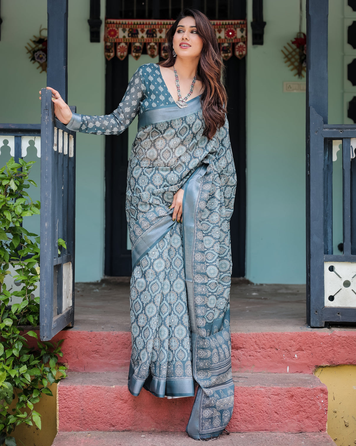 Teal blue pure cotton linen saree with geometric block print blouse and tassel detailing