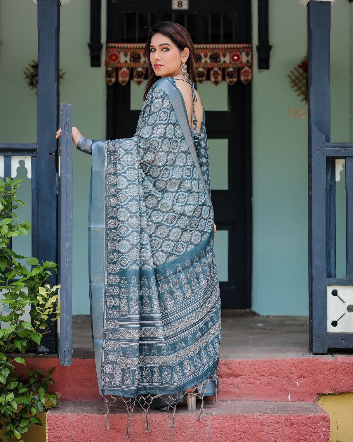 Teal blue pure cotton linen saree with geometric block print blouse and tassel detailing