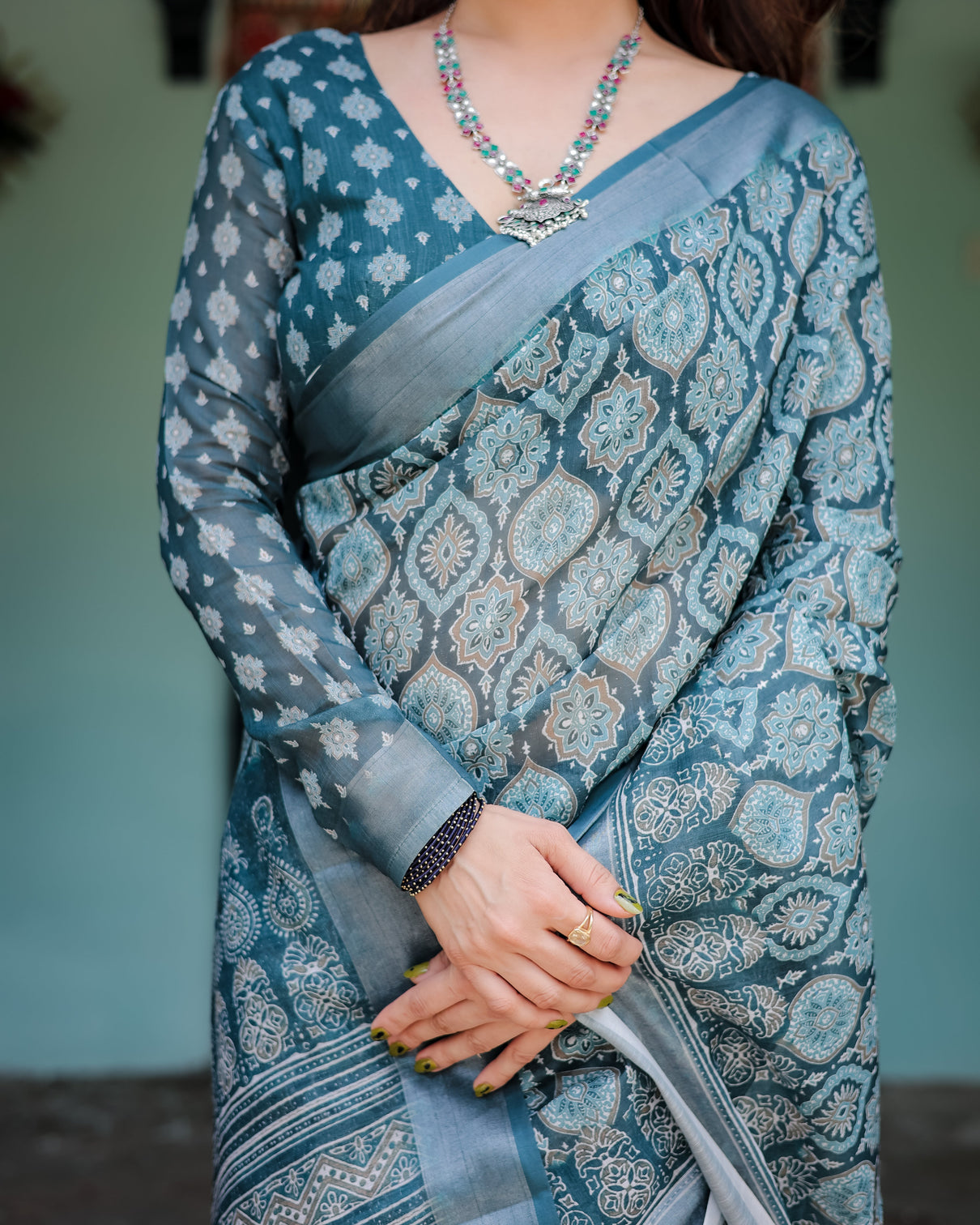 Teal blue pure cotton linen saree with geometric block print blouse and tassel detailing