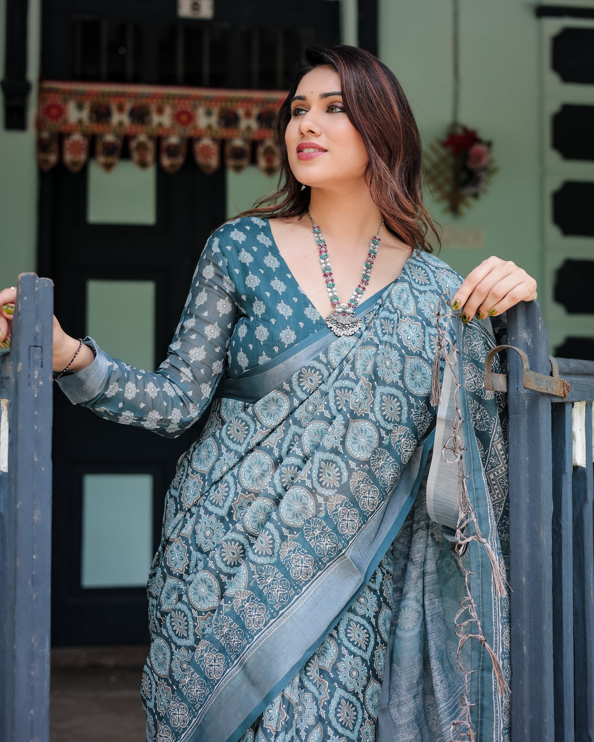 Teal blue pure cotton linen saree with geometric block print blouse and tassel detailing