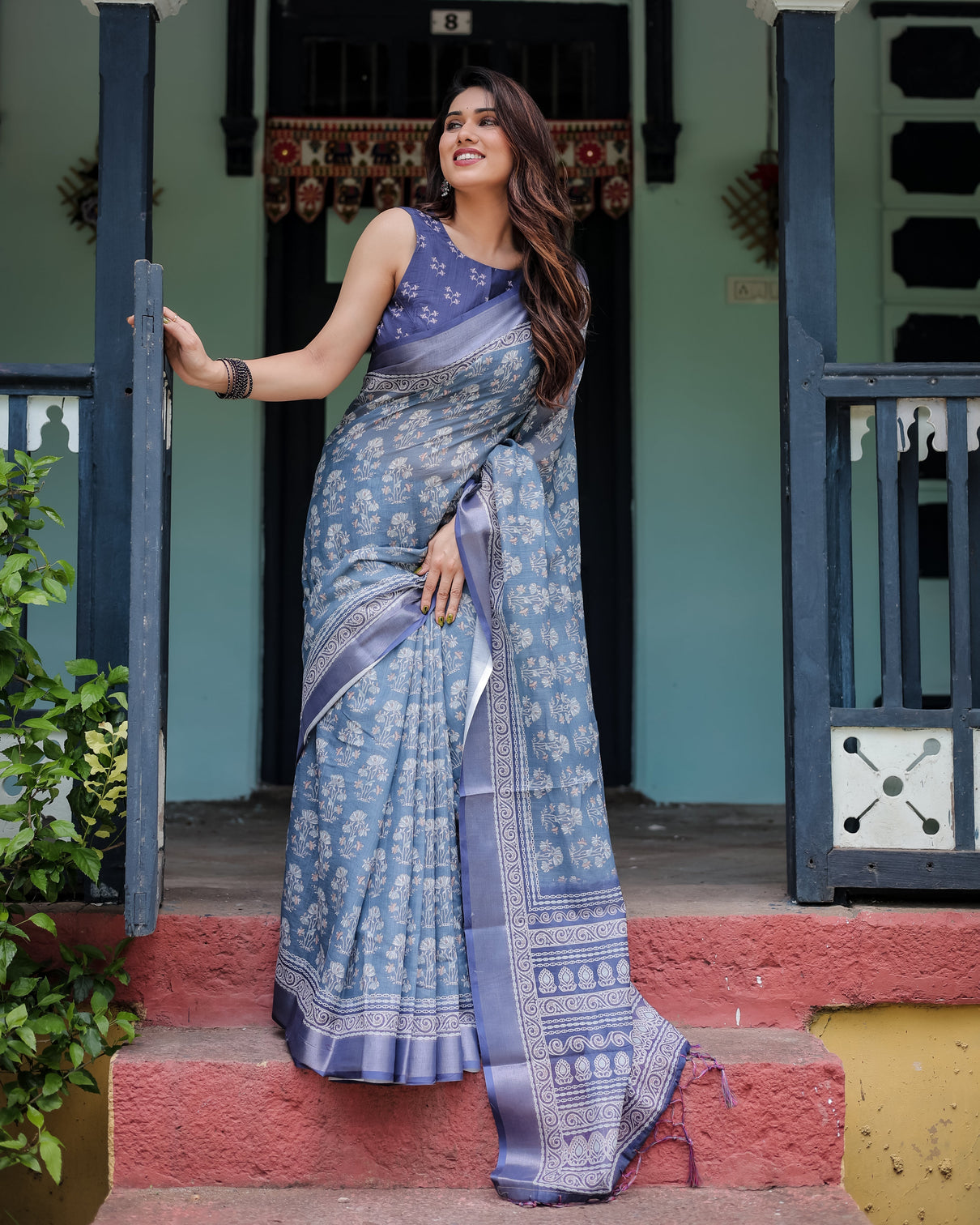 Elegant blue pure cotton linen saree with floral pattern blouse and tassels on edges