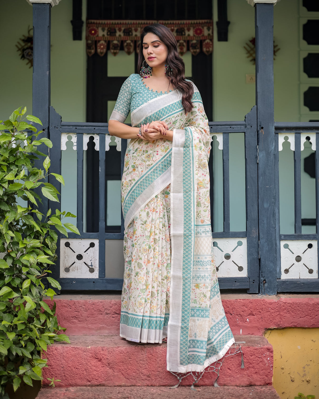 Elegant floral printed pure cotton linen saree in ivory with teal border and blouse tassels on edges