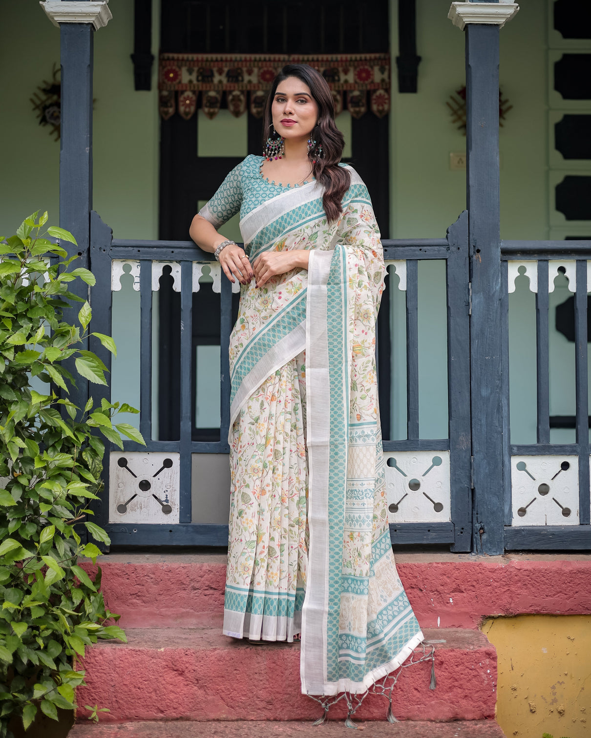 Elegant floral printed pure cotton linen saree in ivory with teal border and blouse tassels on edges
