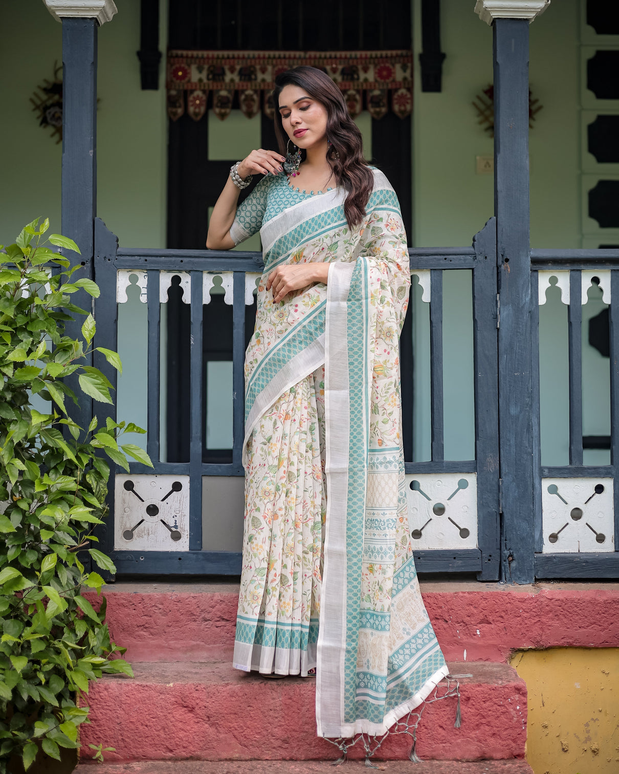 Elegant floral printed pure cotton linen saree in ivory with teal border and blouse tassels on edges