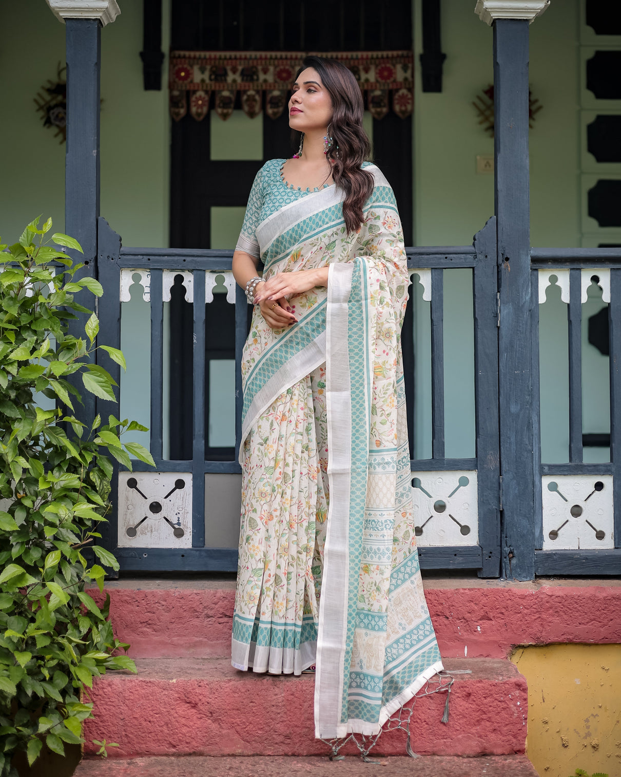 Elegant floral printed pure cotton linen saree in ivory with teal border and blouse tassels on edges