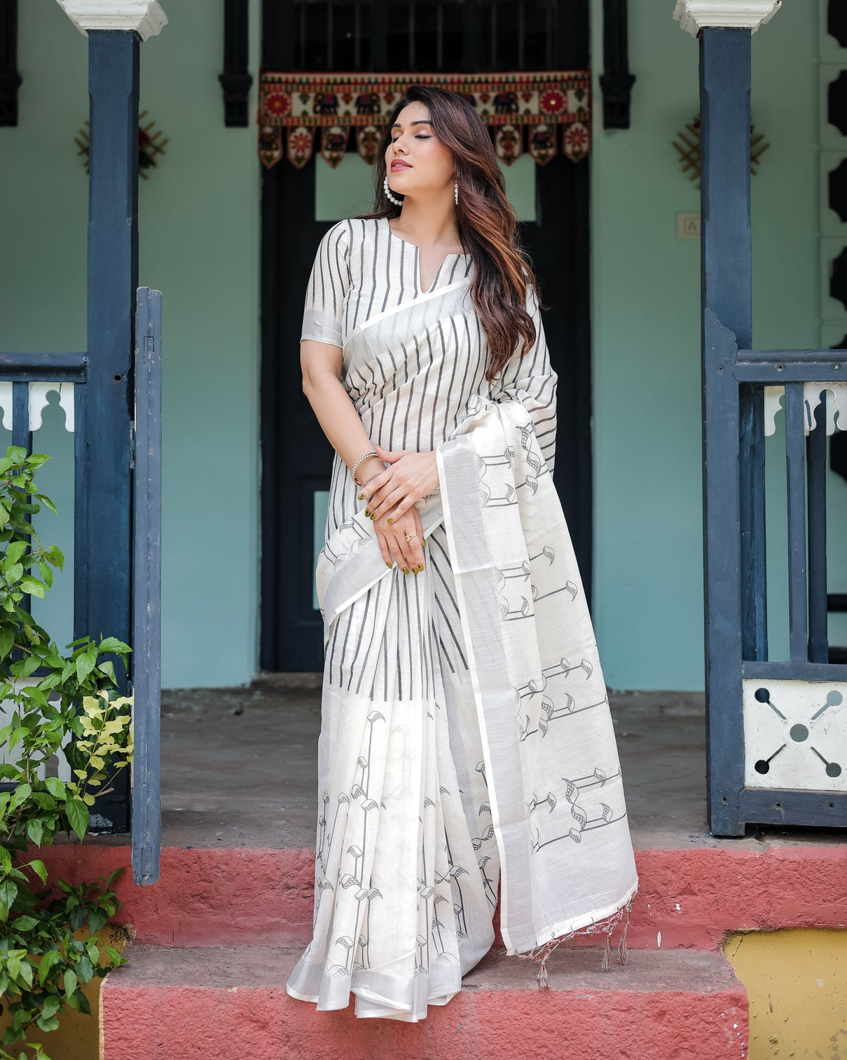 White and black pure cotton linen saree with striped pattern blouse and tassel detailing