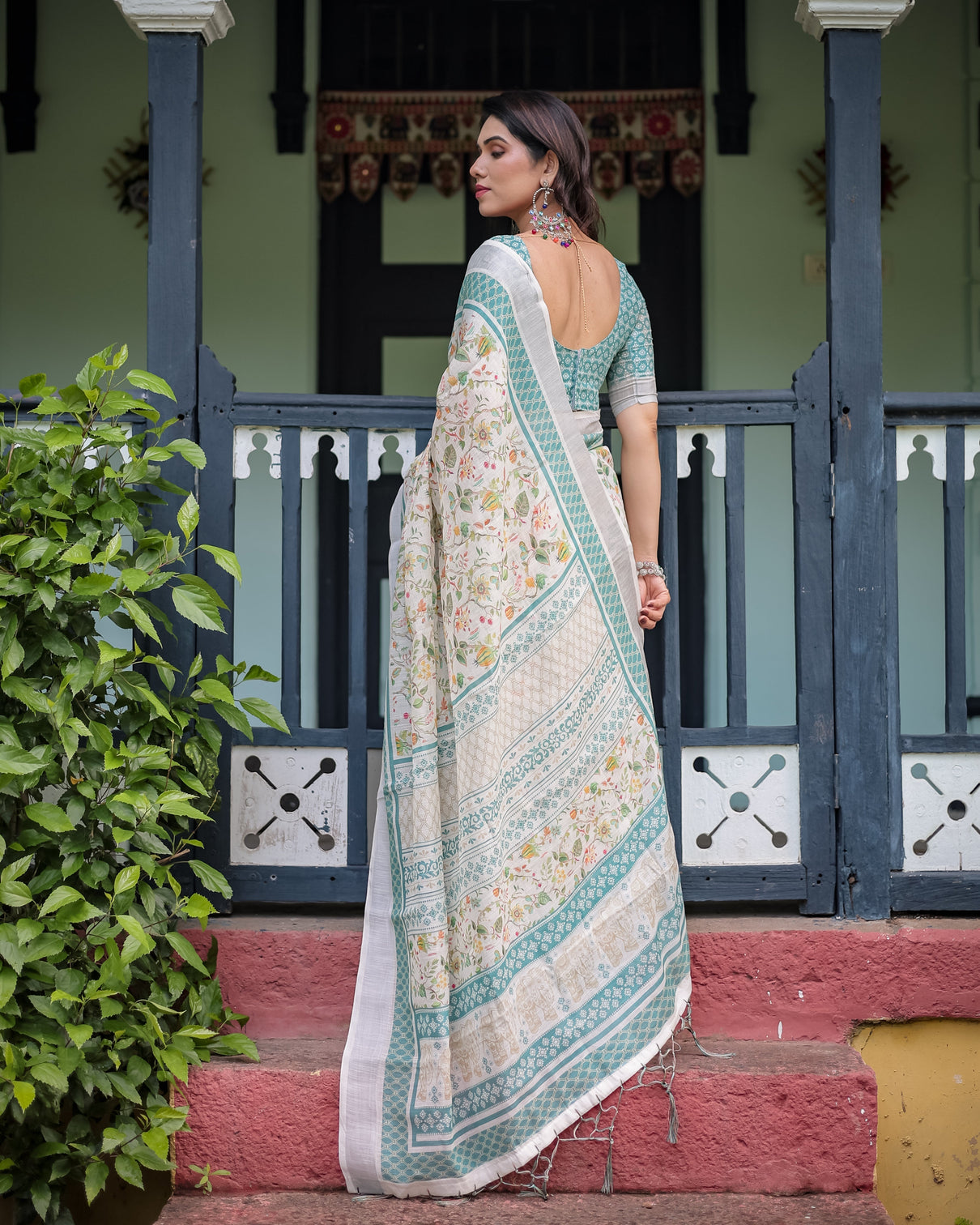 Elegant floral printed pure cotton linen saree in ivory with teal border and blouse tassels on edges