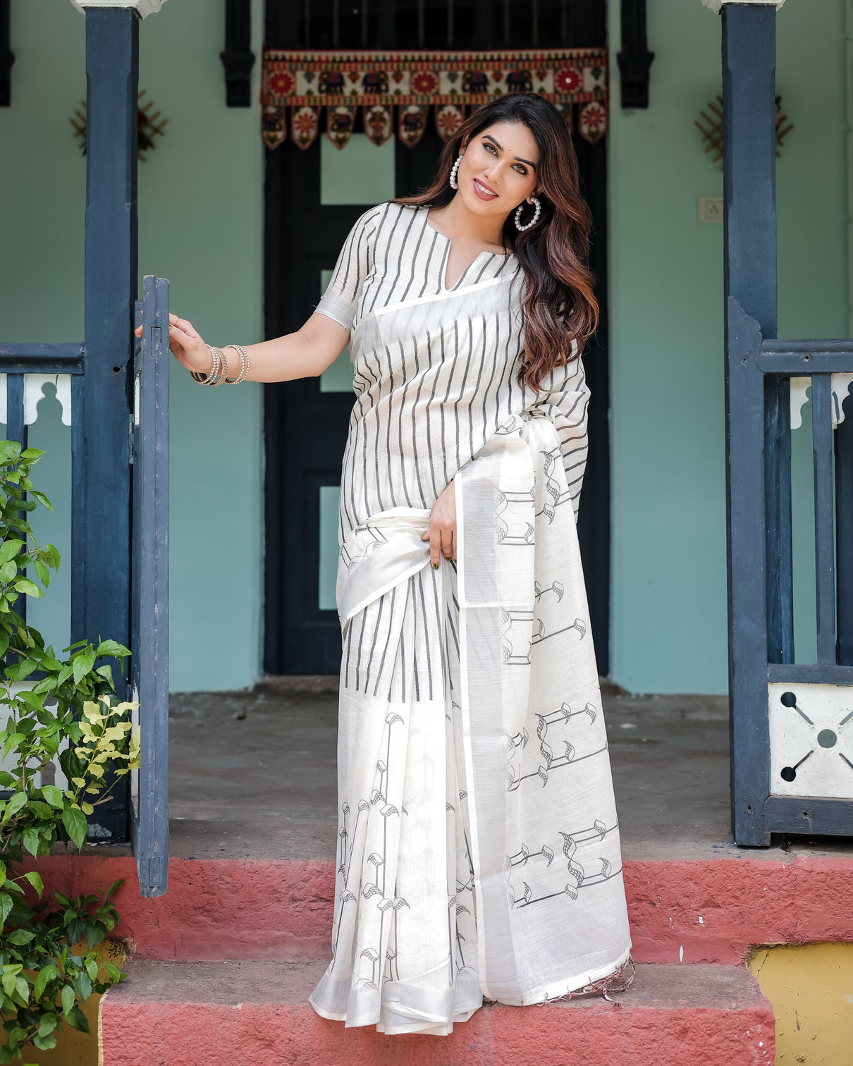 White and black pure cotton linen saree with striped pattern blouse and tassel detailing