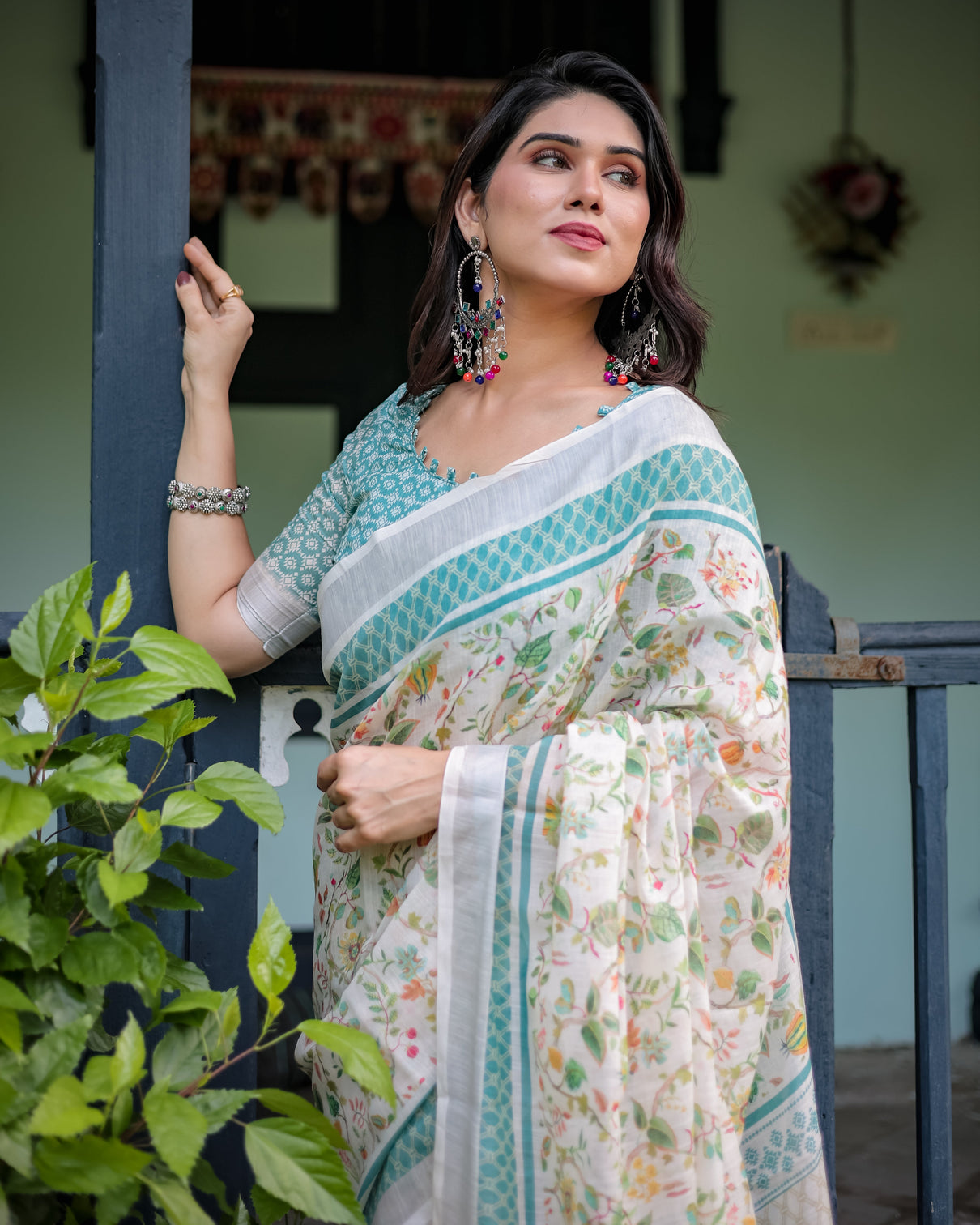 Elegant floral printed pure cotton linen saree in ivory with teal border and blouse tassels on edges