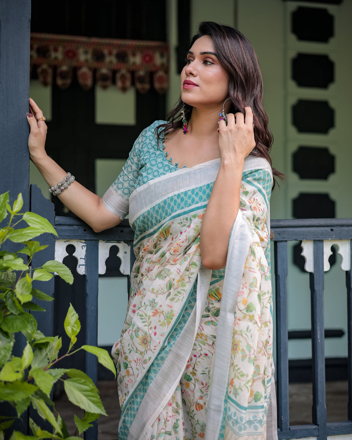 Elegant floral printed pure cotton linen saree in ivory with teal border and blouse tassels on edges