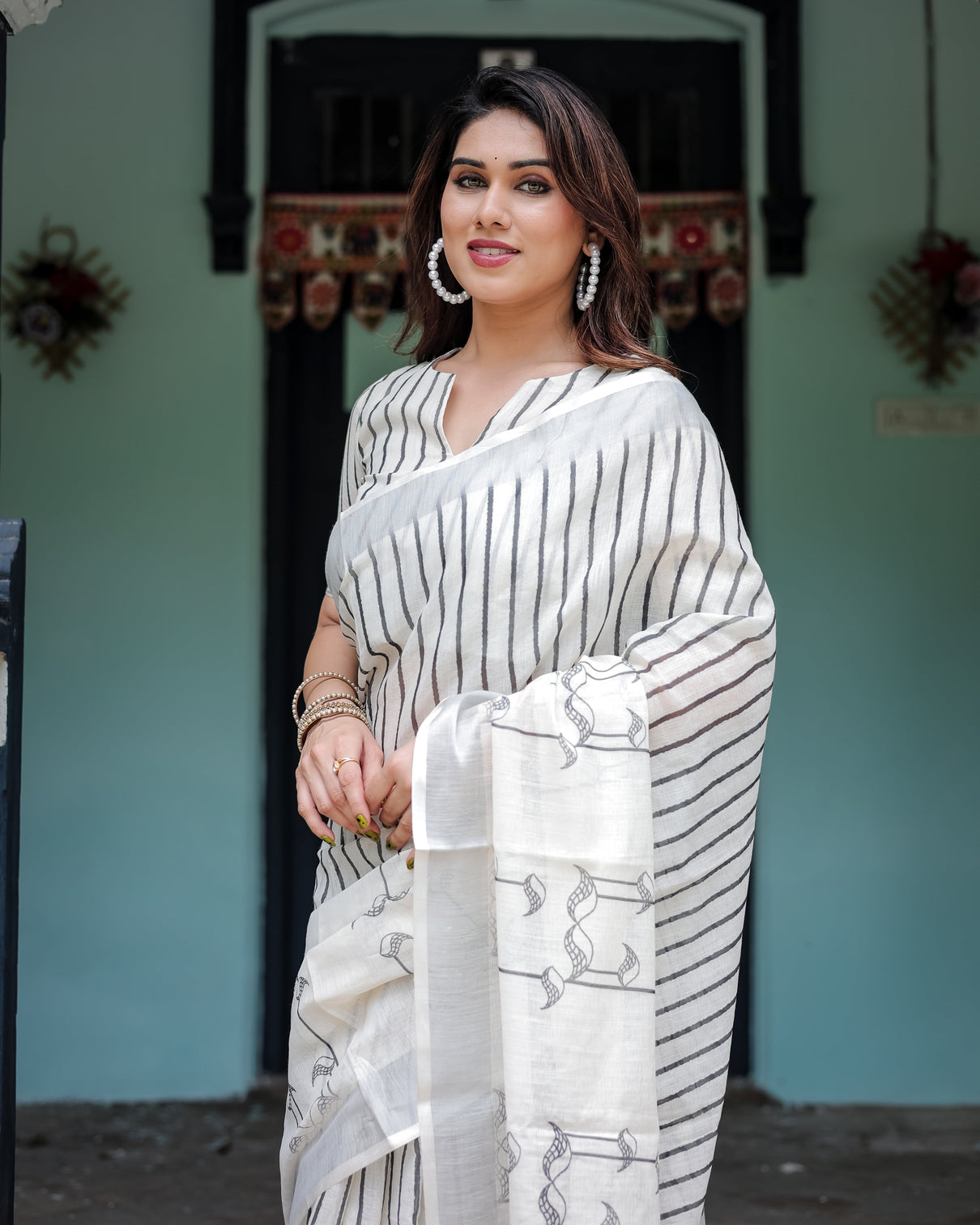 White and black pure cotton linen saree with striped pattern blouse and tassel detailing