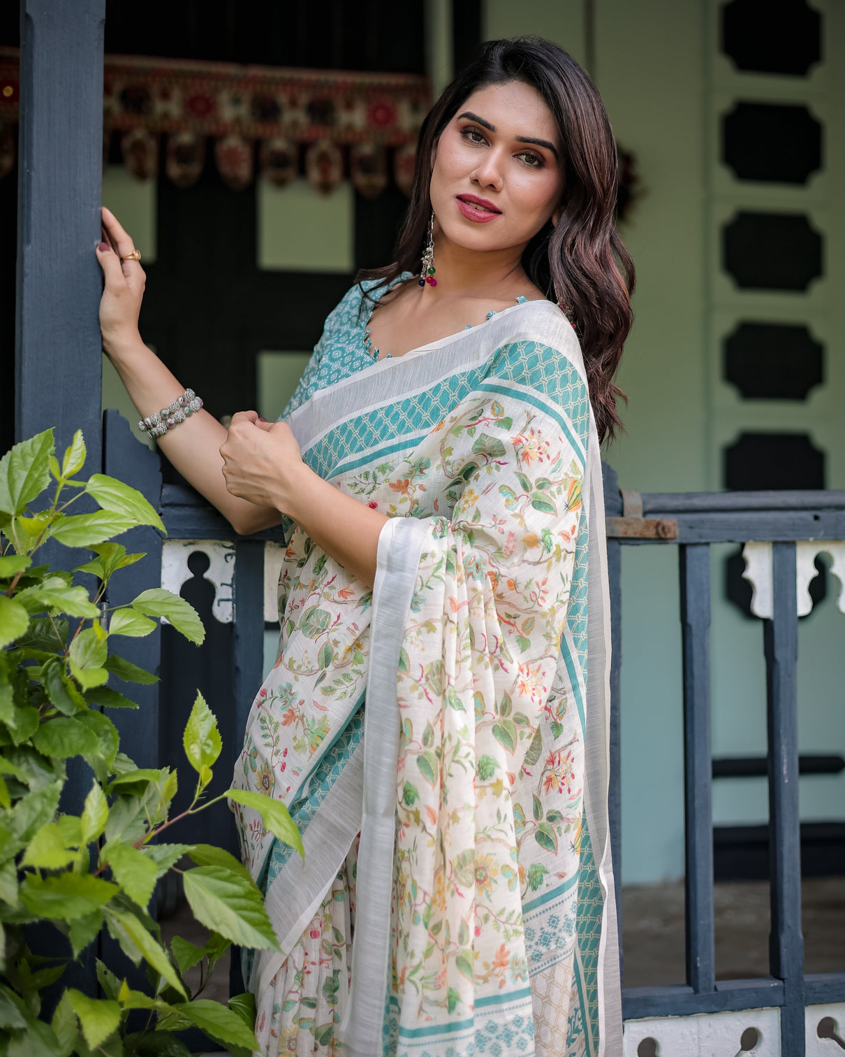 Elegant floral printed pure cotton linen saree in ivory with teal border and blouse tassels on edges