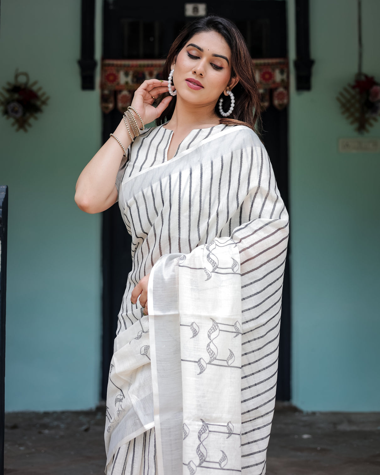 White and black pure cotton linen saree with striped pattern blouse and tassel detailing