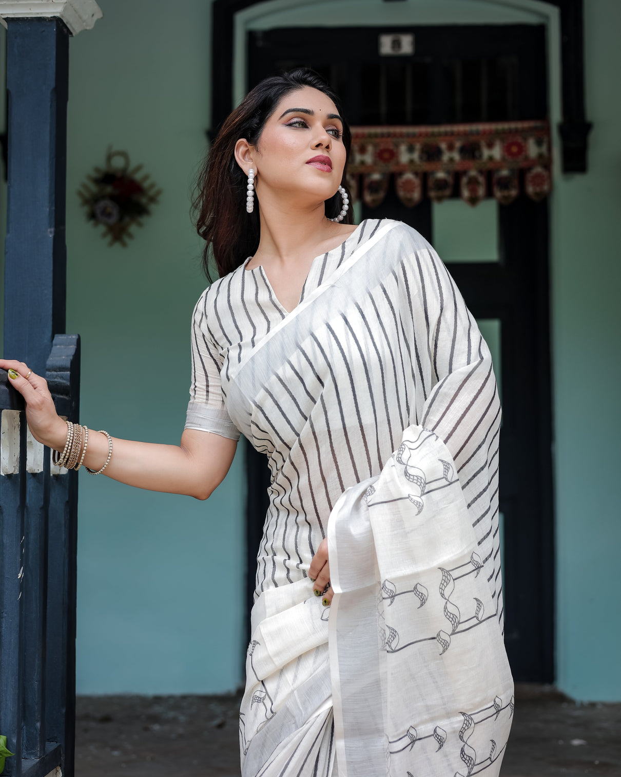 White and black pure cotton linen saree with striped pattern blouse and tassel detailing